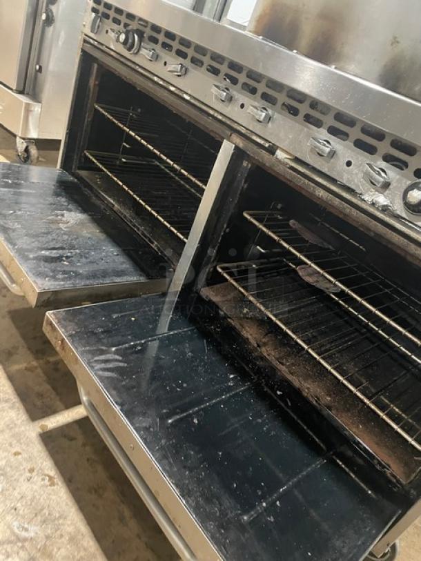 Bakers Pride stainless steel 10-burner gas range with double oven, overhead salamander shelf, and backsplash. Includes wired oven racks.