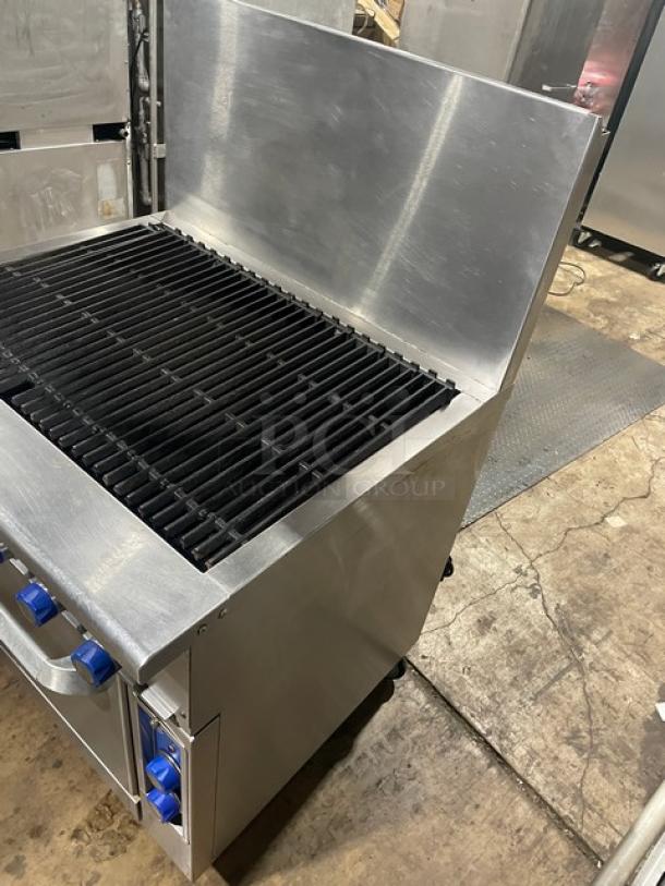 Imperial commercial stainless steel char broiler range and convection oven combo with backsplash and wired oven rack on casters.
