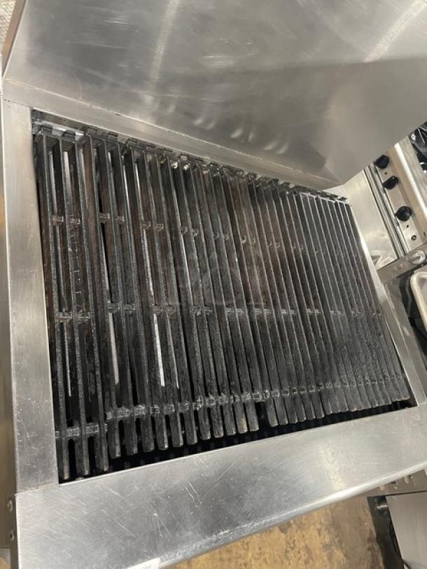 Imperial stainless steel gas-powered radiant char broiler range with convection oven and backsplash. Includes wired oven rack.