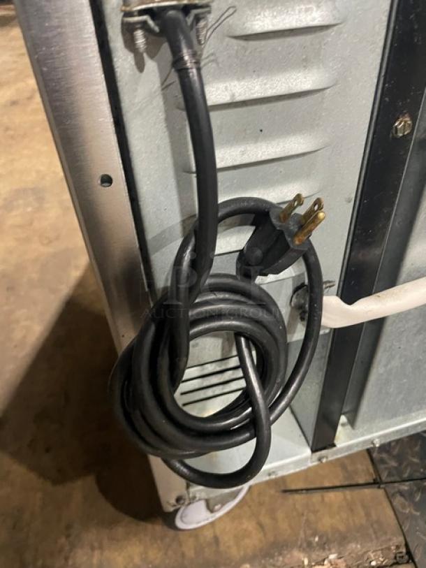 Imperial commercial stainless steel char broiler range and convection oven combo, featuring a backsplash and wired rack, on casters.