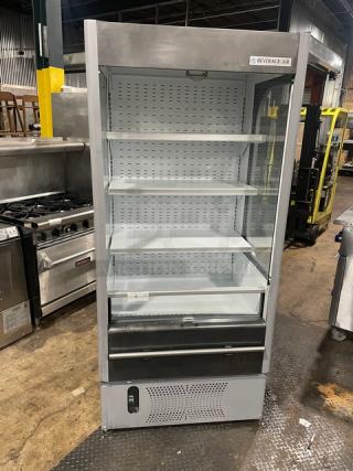 Beverage Air VM12 refrigerated open merchandiser, white, multi-tier, adjustable shelving, model and serial number visible.