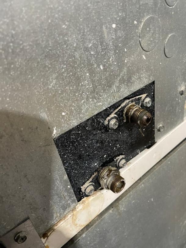 Close-up of Manitowoc Koolaire ice maker connections, KY0350W-161 model. Stainless steel, shows wear. Electric, 115V, 1 phase.