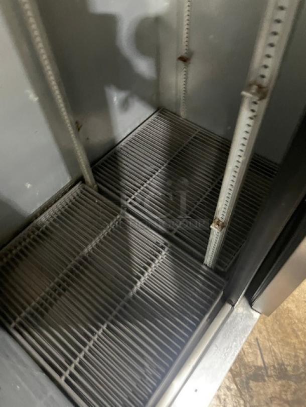 True T35HC commercial stainless steel reach-in refrigerator interior with wire racks, model T-35-HC, on casters.