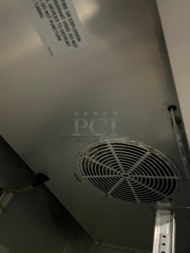 True Commercial T-35-HC stainless steel reach-in refrigerator interior, showing fan and wiring; durable, on casters, 115V.