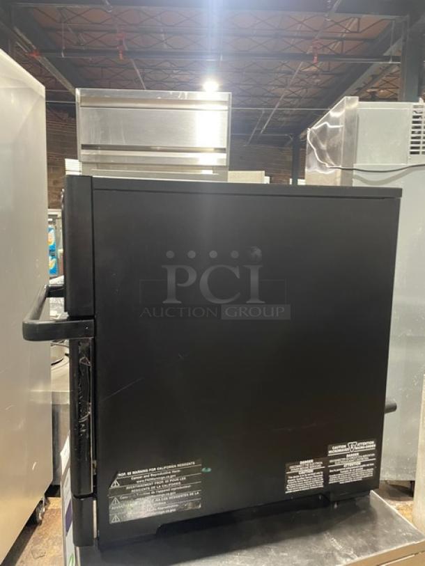 MerryChef commercial black electric countertop high-speed rapid cook oven, sleek design, visible operational labels.