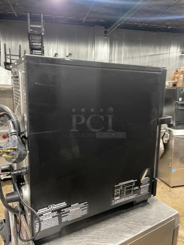 MerryChef black electric countertop high-speed rapid cook oven, visible power cord, side ventilation, good condition.