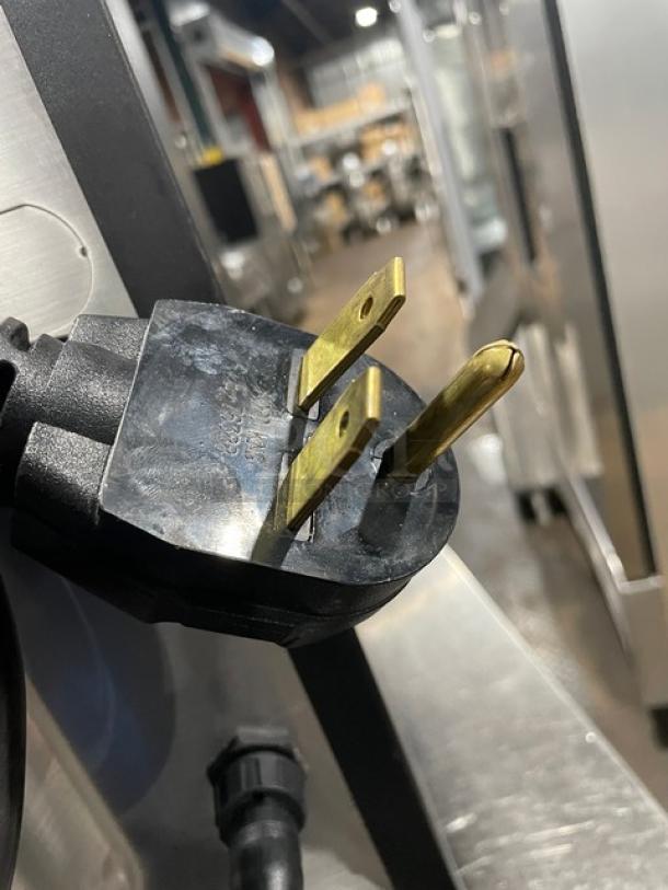 Close-up of a MerryChef commercial oven plug. Black, electric-powered countertop rapid cook oven.