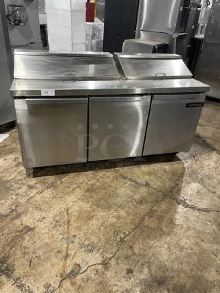 Continental stainless steel 3-door refrigerated prep table, model SW72-18, on casters, with poly-coated wired rack.