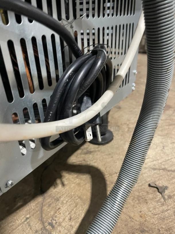 Coldline ICE120HA undercounter ice maker, stainless steel, model 2020, on legs, shown with power cord and hoses.