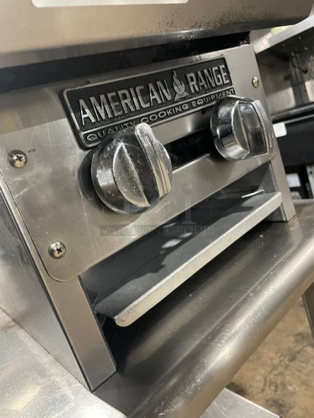 American Range commercial stainless steel gas-powered double stock pot range with controls and manufacturer's logo visible.