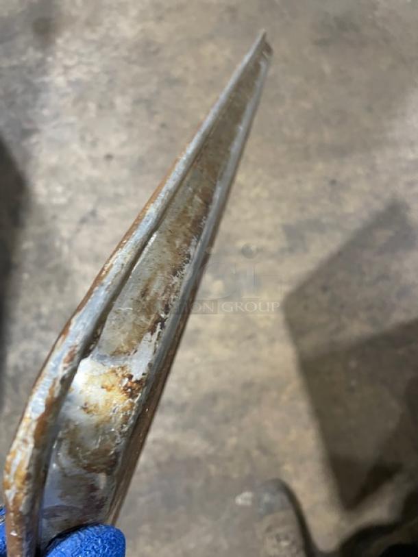 Alt text: Close-up of commercial perforated sheet pan edge showing rust and wear. Used condition, sturdy construction.