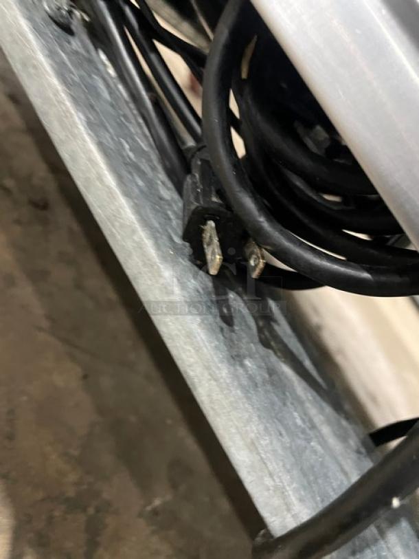 CoolTech CMPH60BM prep table power plug and cable. Visible standard 120V plug, coiled for storage. Efficient and durable.