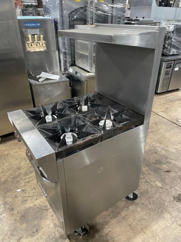 Southbend S241E commercial stainless steel 4-burner range/oven combo with backsplash, overhead salamander shelf, and casters.