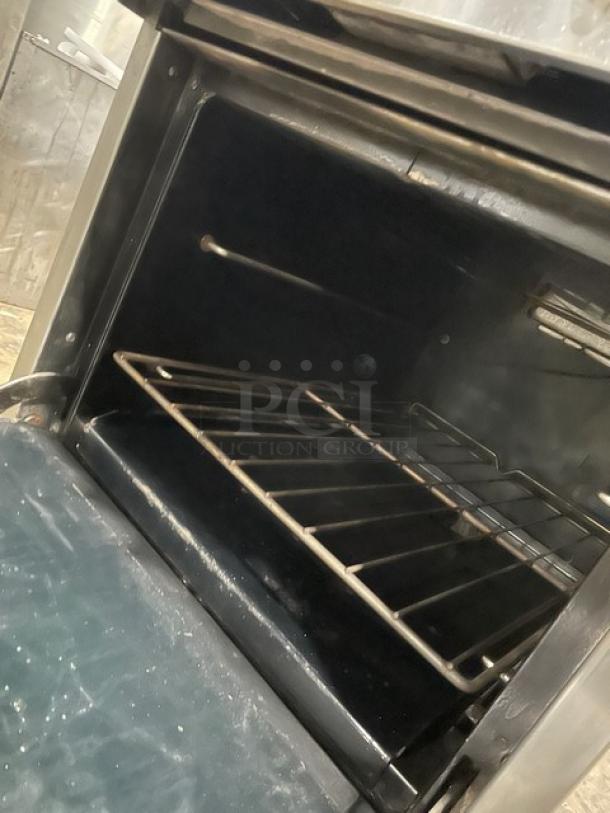 Southbend S241E stainless steel gas range/oven combo with backsplash, overhead salamander shelf, and wired oven rack.