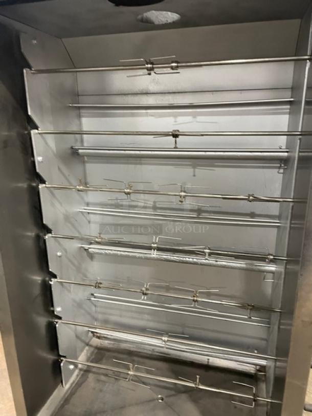 Attias stainless steel gas-powered full-height rotisserie cabinet on casters, featuring multiple skewers, in good condition.