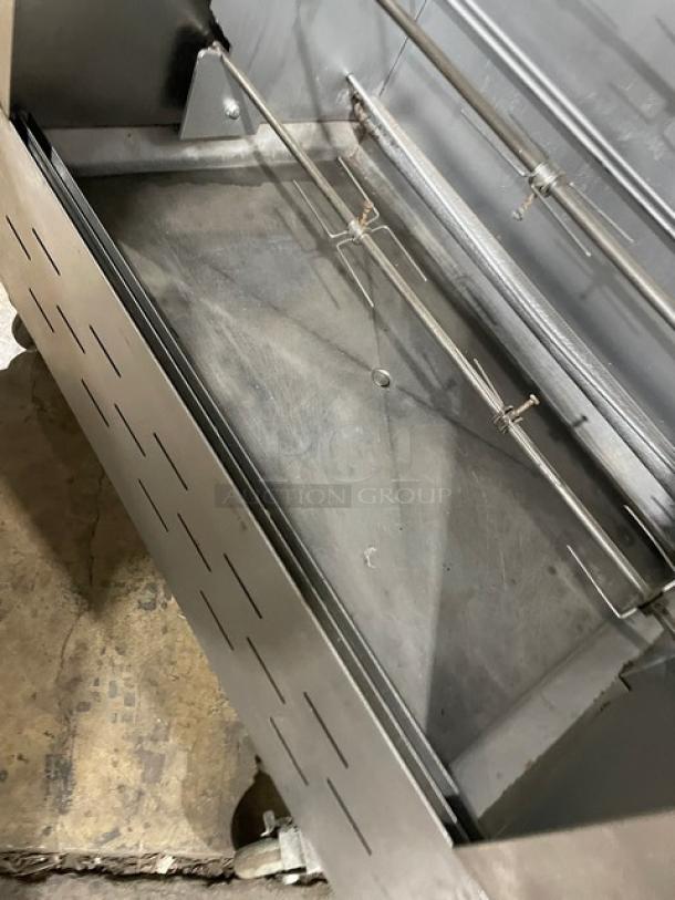 Attias stainless steel gas-powered rotisserie cabinet, full-height, on casters, commercial use, interior view, good condition.