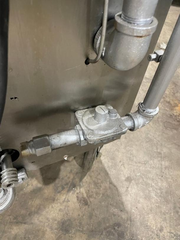 Attias stainless steel gas-powered rotisserie cabinet close-up. Features caster wheels, gas connection details, full-height design.