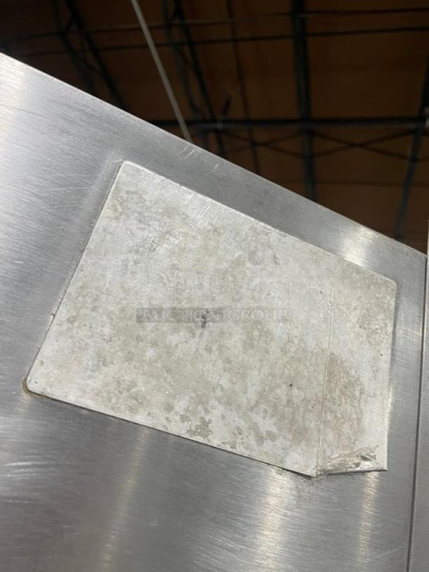 Attias stainless steel gas rotisserie cabinet on casters, full-height, commercial use, visible wear on top surface.