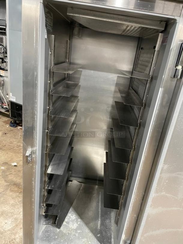 Continental DL1RE-PT commercial stainless steel pass-thru refrigerator with built-in pan slide, single door, on legs.