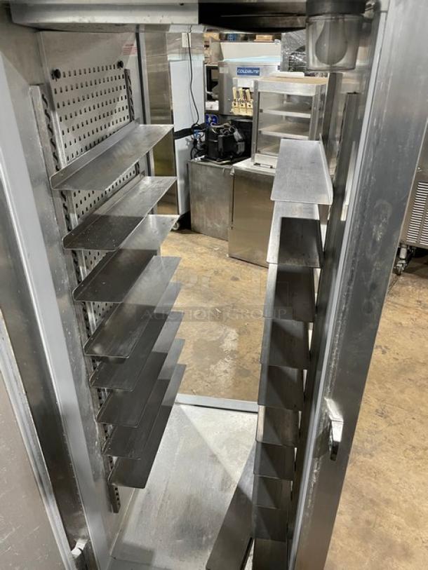 Continental DL1REPT stainless steel pass-thru refrigerator with built-in pan slide, 115V, single door, on legs.