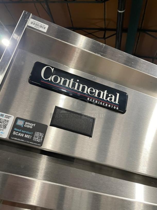 Continental DL1REPT refrigerator, stainless steel, single door, extra wide, pass-thru model, built-in pan slide, on legs.