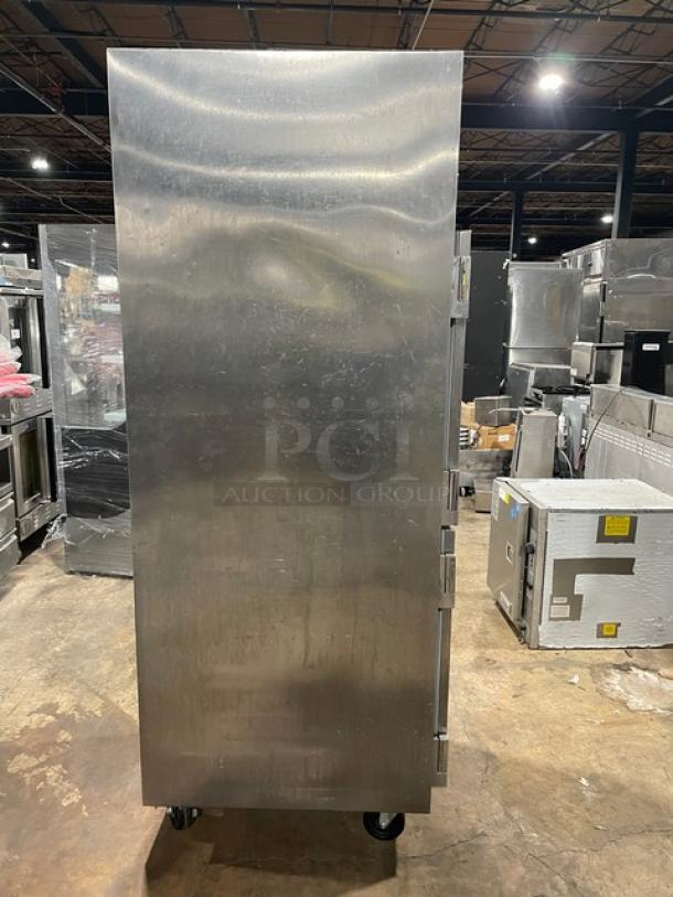 Traulsen AHT132DUTHHS stainless steel reach-in refrigerator, single section, solid half door, on casters, with wired racks.