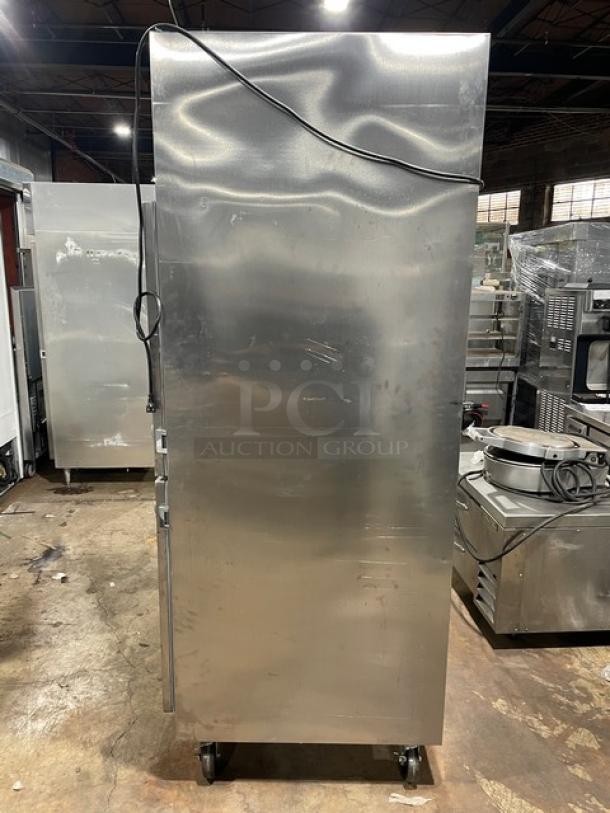 Traulsen commercial stainless steel half door reach-in refrigerator, Model AHT132DUT-HHS, on casters, with wired racks.