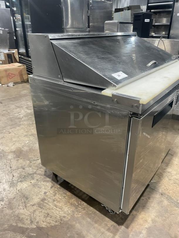 Dukers DSP48 stainless steel 2-door refrigerated salad/sandwich prep table, features cutting board, poly-coated rack, 115V, on casters.