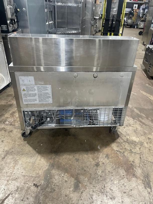 Dukers DSP48 stainless steel 2-door refrigerated prep table, bain marie style, with cutting board, poly-coated rack, model label.