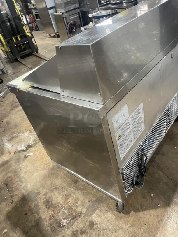 Dukers DSP48 stainless steel 2-door refrigerated prep table with cutting board, poly coated rack, casters; label visible.