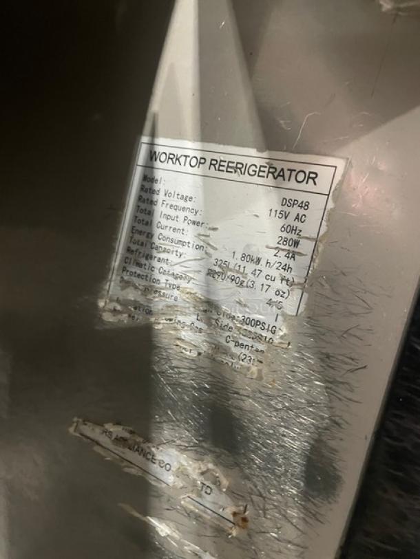 Dukers DSP48 2 Door Refrigerated Prep Table, features stainless steel, cutting board, poly coated rack, 115V, on casters.