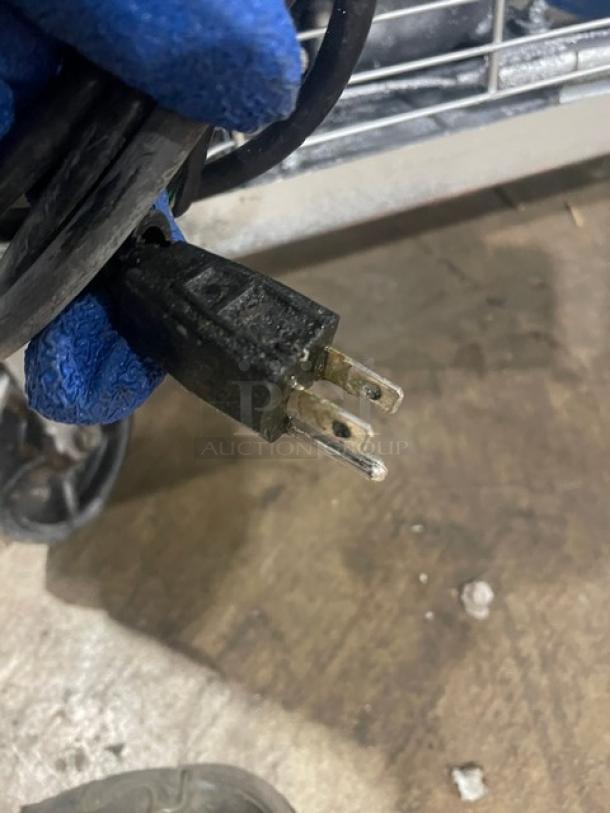 Dukers DSP48 2-Door Bain Marie Prep Table, stainless steel, on casters, with cutting board and rack, 115V plug visible.