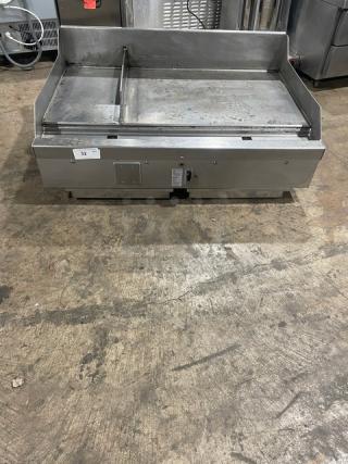 Woodstone stainless steel countertop plancha griddle with split-top style, side and back splash, model WS-PL-4836-4-CT00NG, on legs.