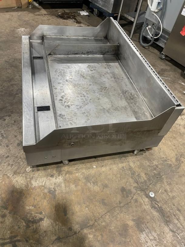 Woodstone stainless steel natural gas griddle, model WS-PL-4836-4-CT00NG, with side and back splash, on legs.