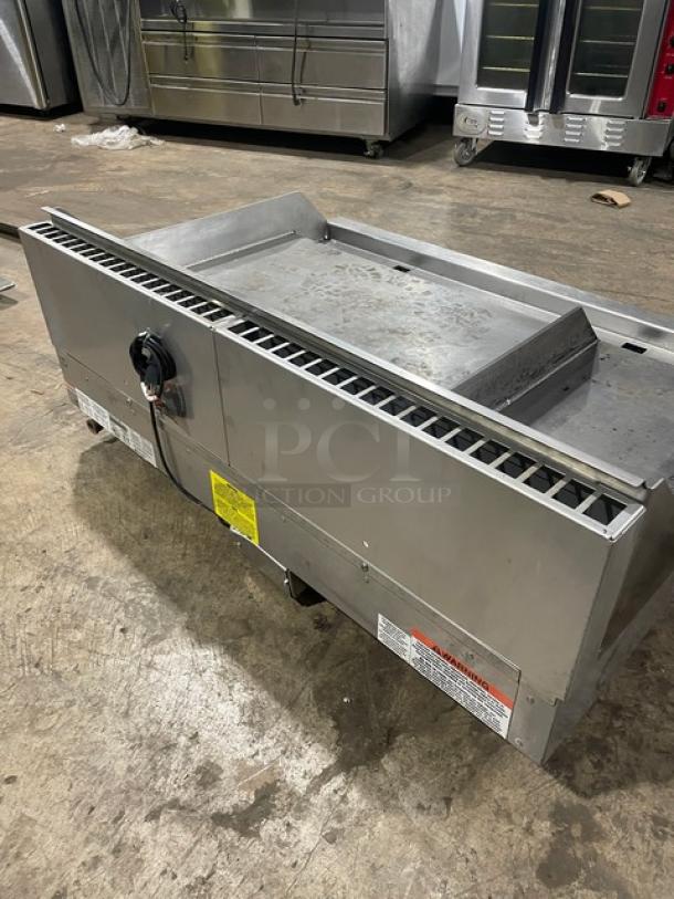 Woodstone stainless steel natural gas plancha griddle, model WS-PL-4836-4-CT00NG, with side and back splash, on legs.