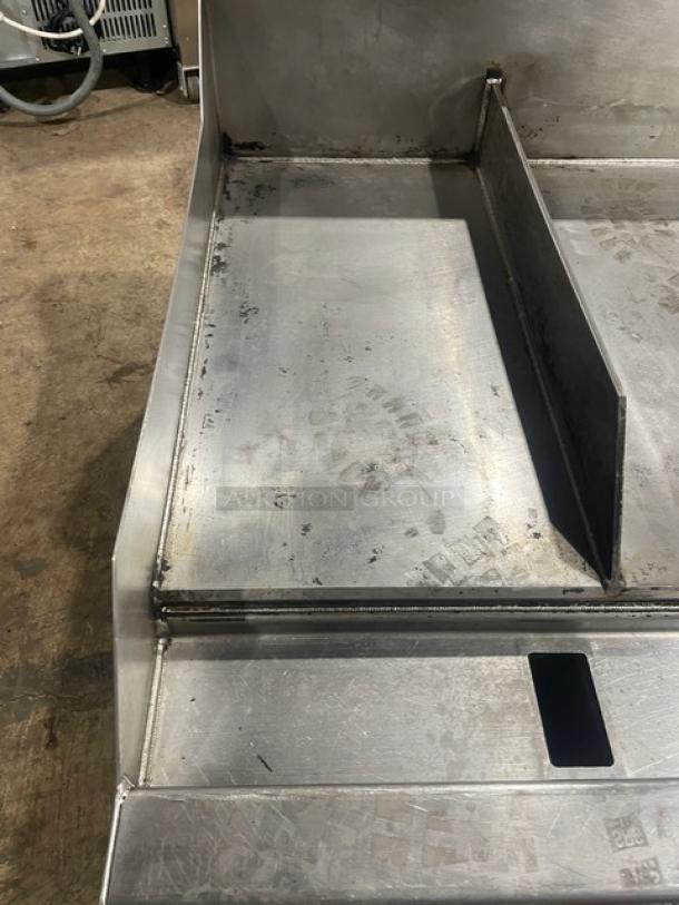 Woodstone stainless steel countertop plancha flat griddle, model WS-PL-4836-4-CT00NG, with side and back splash, on legs.