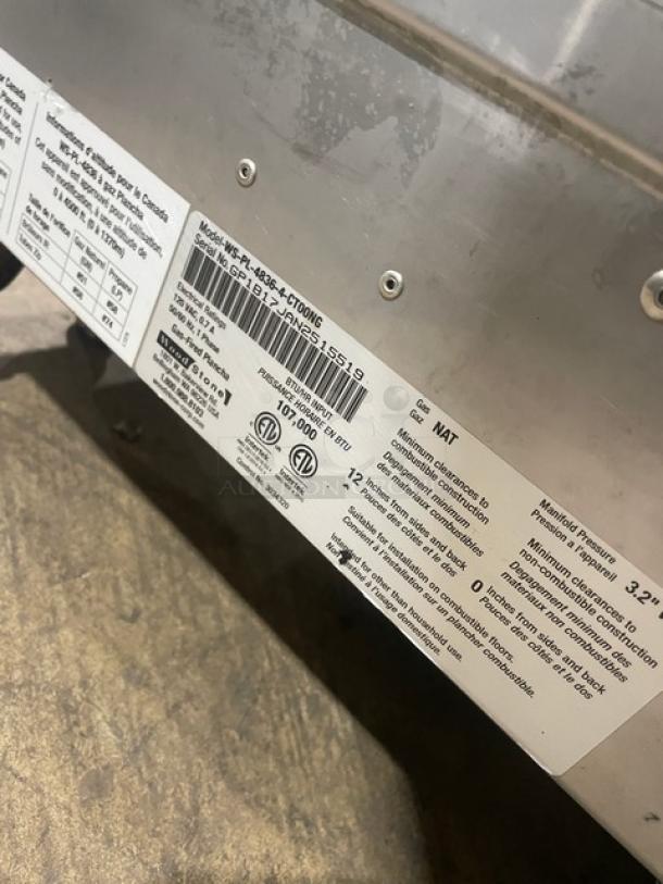 Woodstone stainless steel natural gas countertop plancha griddle, model WSPL48364CT00NG, with side and back splash, on legs.