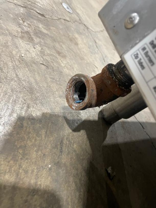 Woodstone commercial griddle connection detail, showing gas inlet and part of the label, model WSPL48364CT00NG.