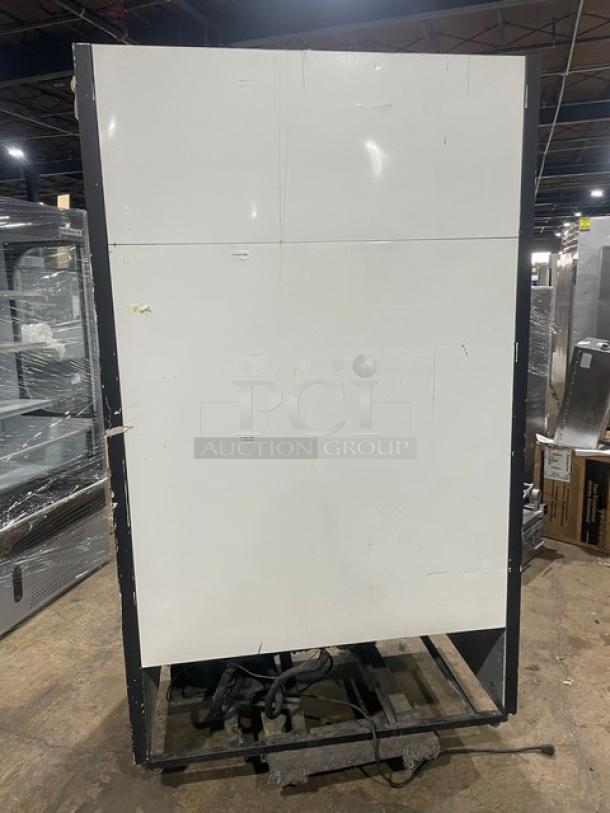 True GDM-41 commercial refrigerator back view, minor wear, black frame, 115V, 1 Phase. Model and serial numbers visible.