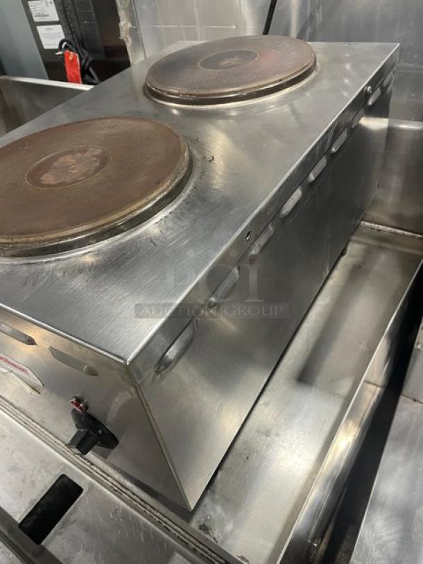 Cecilware stainless steel electric hot plate with two burners on legs. Durable commercial-grade kitchen appliance.