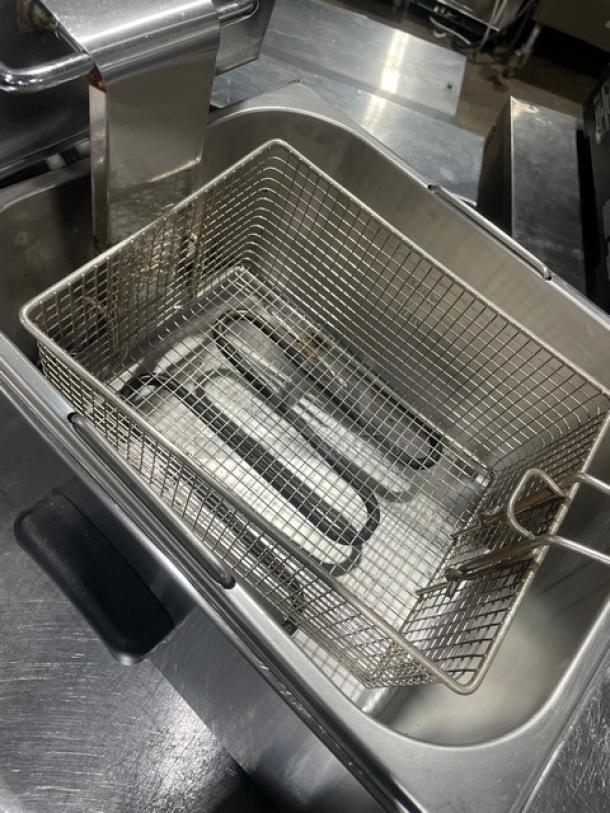 Avantco 177F100 commercial stainless steel countertop deep fat fryer with backsplash and fry basket, 120V.