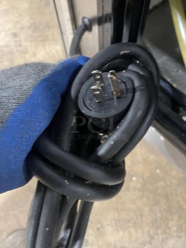 A three-prong power cord for a commercial stainless steel bakery display case, showing durability and design.