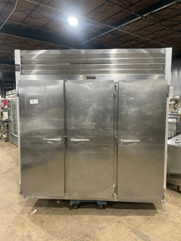 Traulsen stainless steel triple door reach-in freezer, Model T15930D09, Energy Star certified, on casters, with poly coated wired rack.
