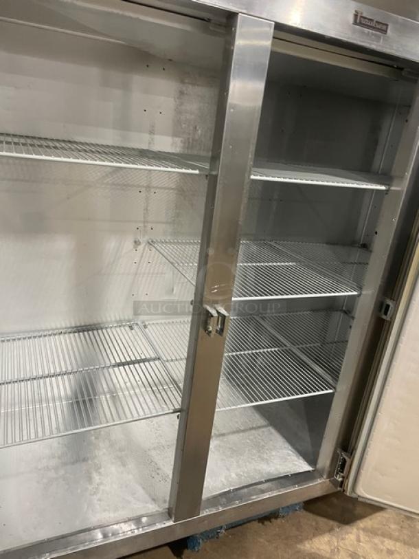 Traulsen stainless steel triple door freezer, model T15930D09, with poly coated racks, Energy Star certified, on casters.