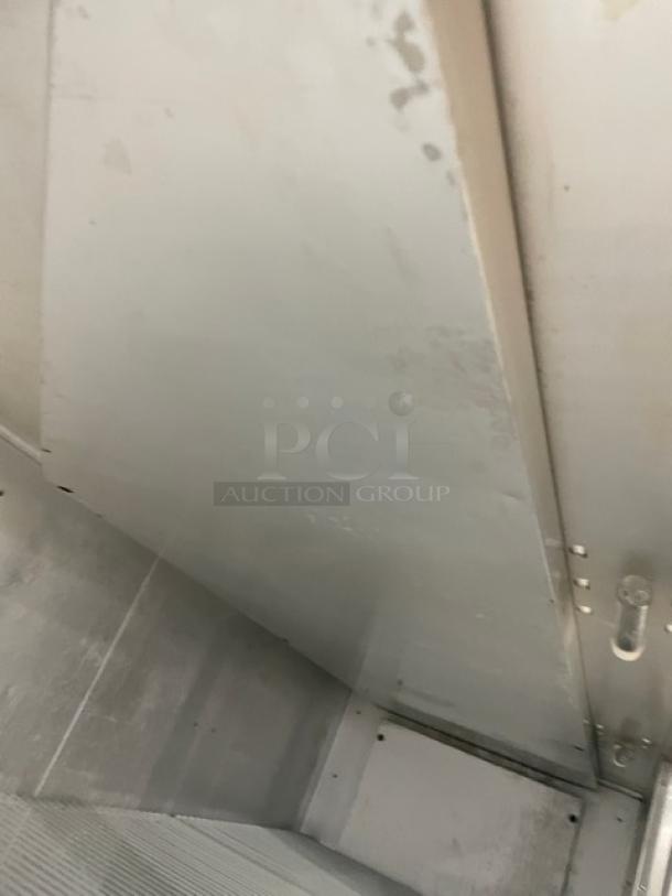 Traulsen stainless steel triple door reach-in freezer, model T15930D09. Energy Star certified with poly-coated rack, on casters.