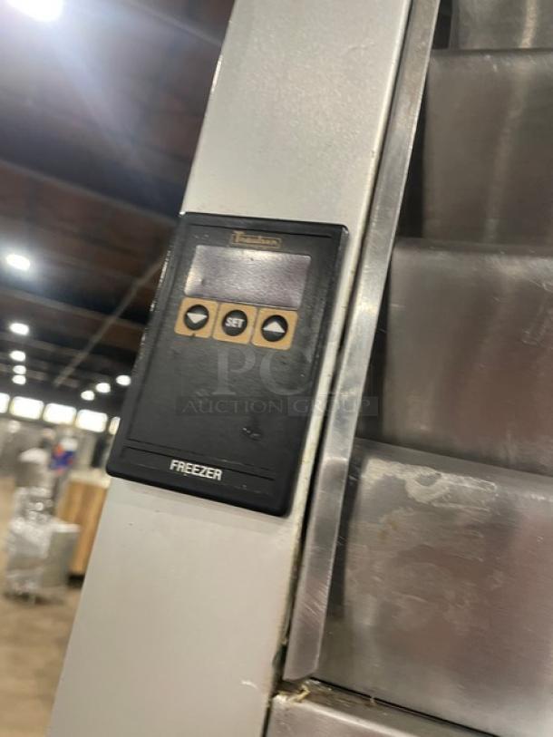 Traulsen stainless steel triple door reach-in freezer, model T15930D09, with control panel, on casters. Energy Star certified.