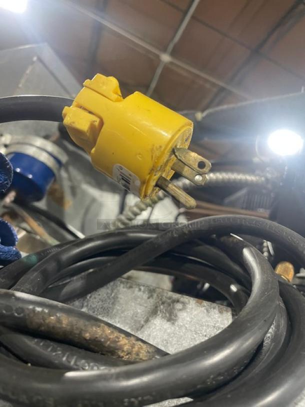 Yellow electrical plug and black cord for the Traulsen G31010 commercial freezer, highlighting the 115V connection.