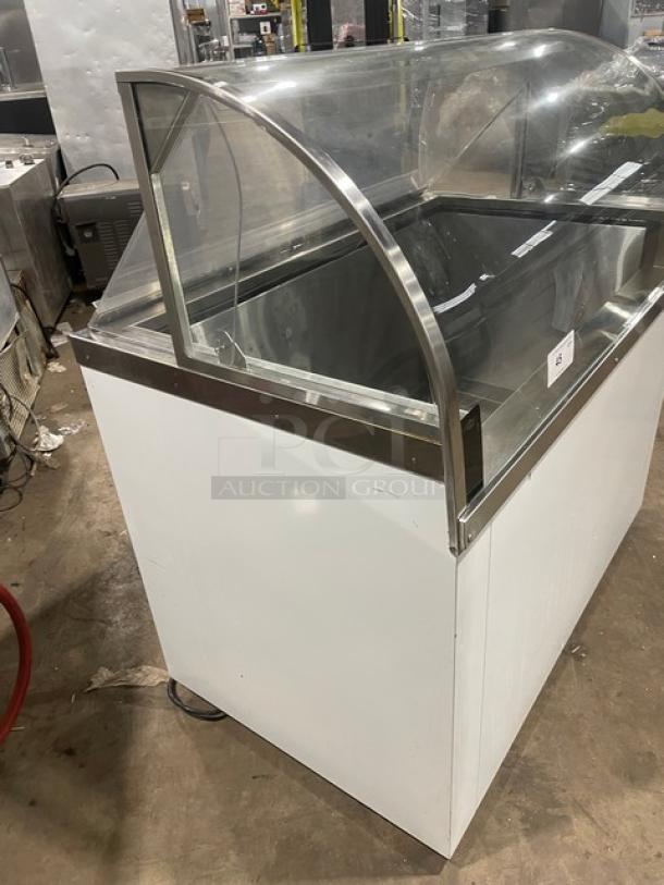Commercial white 46" curved glass ice cream/yogurt dipping cabinet with rear lift-open access. SN: N1902303.