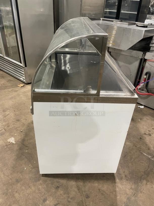 Commercial white curved glass 46" ice cream cabinet with rear lift-open access. SN: N1902303, used condition.