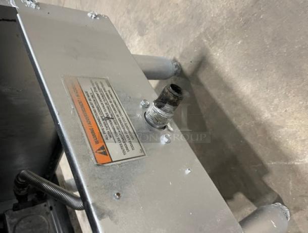 Trialator Commercial 40lb. Stainless Gas Deep Fat Fryer with backsplash, on legs. Visible safety label; used condition.